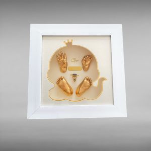 Mẫu tranh Baby Art được thiết kế với khung vuông trắng thanh lịch, kích thước 30x30cm, nền kem nhẹ nhàng và trung tâm là tạo hình em bé đội vương miện viền vàng nổi bật. Bên trong tranh là dấu tay – dấu chân 3D của bé phủ màu vàng ánh kim, kết hợp tên bé và thông tin kỷ niệm ngày sinh. Sản phẩm nhỏ gọn, sang trọng, phù hợp để trưng bày trong phòng bé, phòng ngủ gia đình hoặc làm quà tặng đầy tháng, thôi nôi, sinh nhật đầu đời.